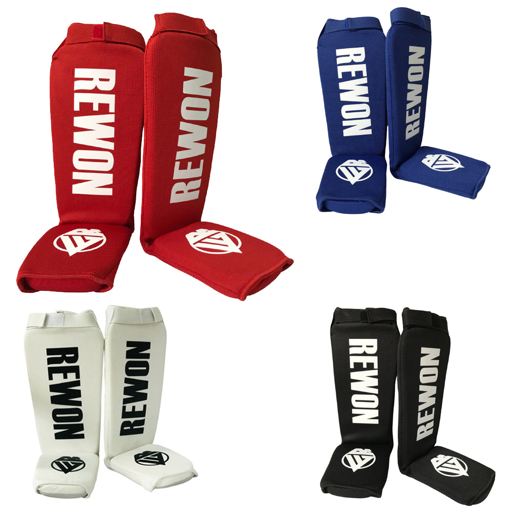 Rewon shin guards for kickboxing in red, blue, white, and black, designed for comfortable and adjustable fit during boxing training.