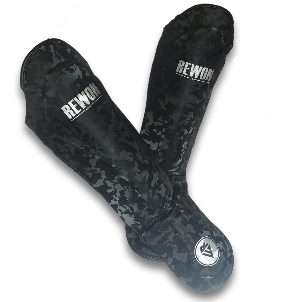Night camo shin guards for kickboxing or MMA training, featuring durable camo design and Rewon branding for fitness enthusiasts.