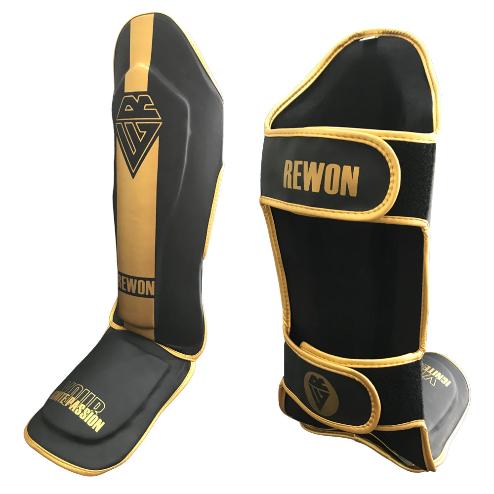 Rewon classic black and gold shin guards for kickboxing, featuring durable synthetic leather and secure Velcro straps.