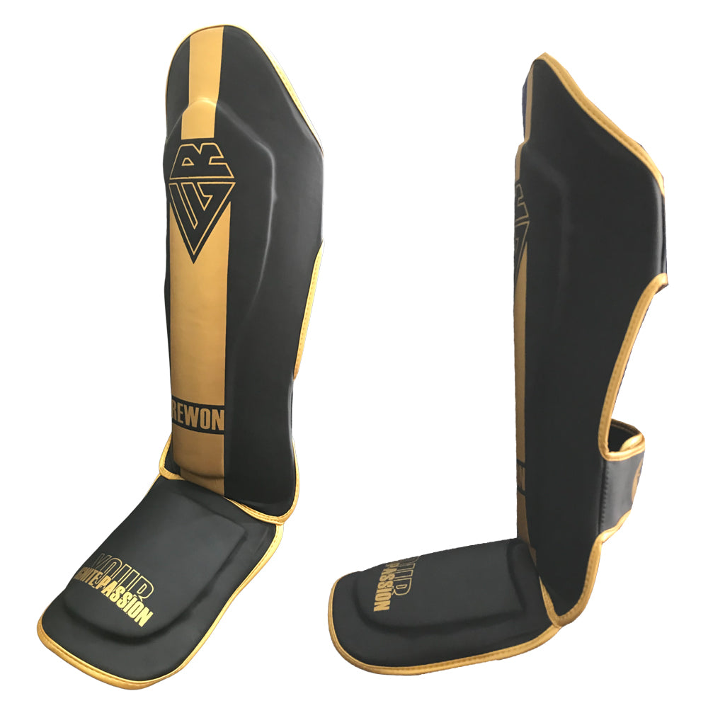 Rewon Classic black and gold shin guards for kickboxing, MMA, and boxing, featuring enhanced protection and comfort for training.