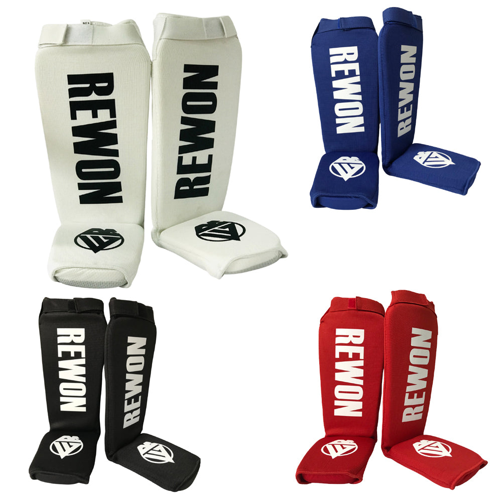 White Rewon shin guards for kickboxing and MMA, comfortable fit with adjustable straps, ideal for fitness and martial arts training.
