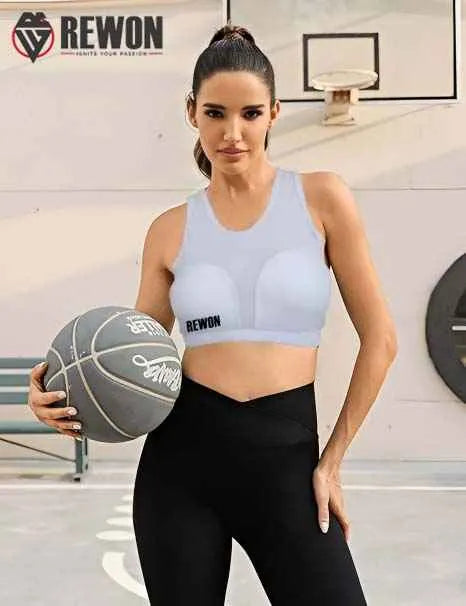 Woman wearing Rewon white sports bra holding a basketball, ideal for boxing, kickboxing, and fitness training.