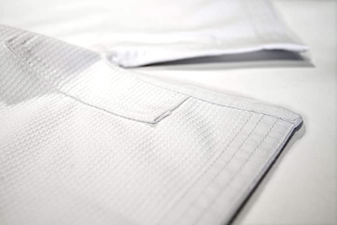 White Rewon Basic 1.5 Ju Jutsu Gi showing fabric texture, ideal for martial arts and fitness like boxing and MMA, includes free belt.