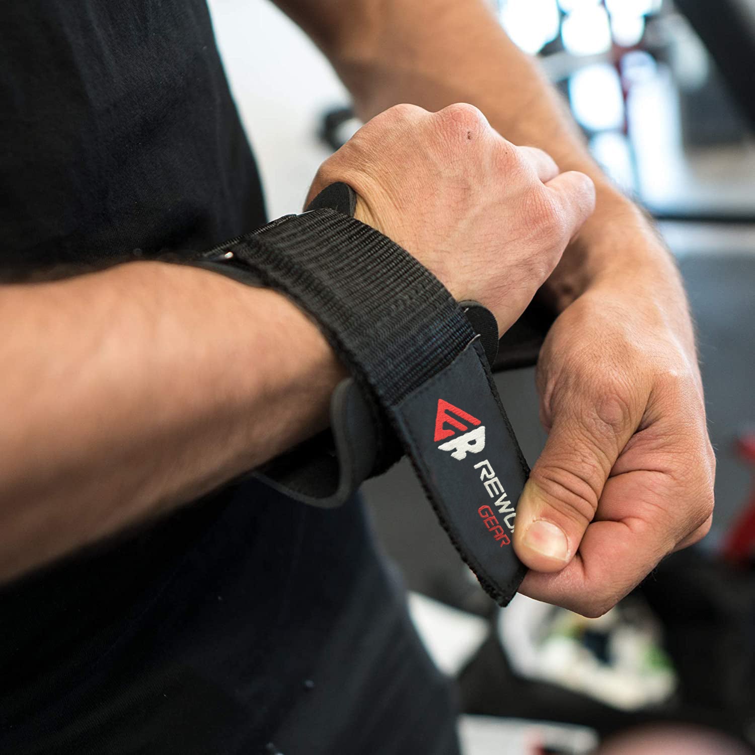 Man wearing Rewon weightlifting hand grips for boxing and fitness training.